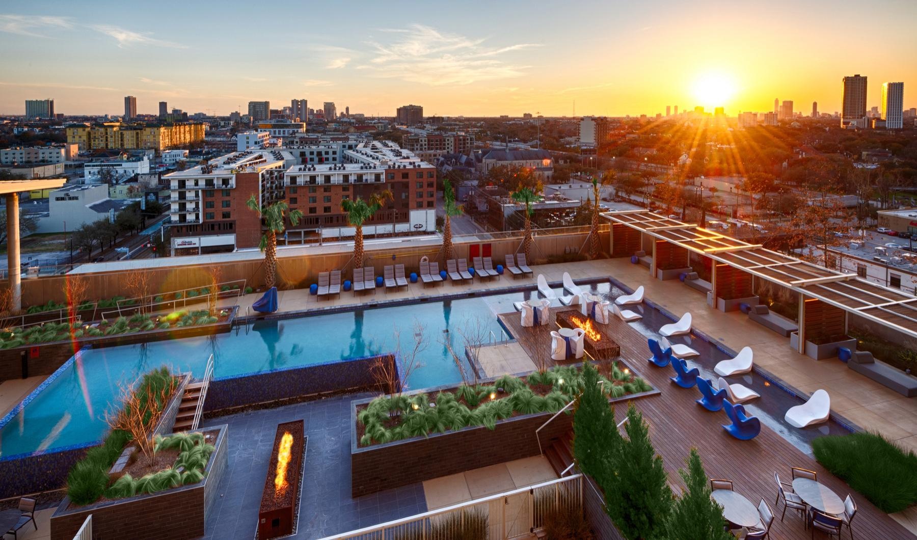 Find your perfect fit at The Travis a pool and buildings with a sunset