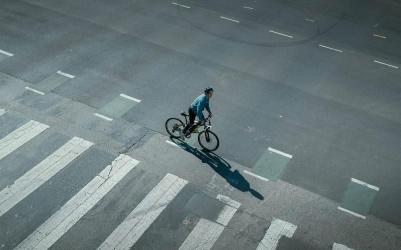 a person riding a bicycle on a street